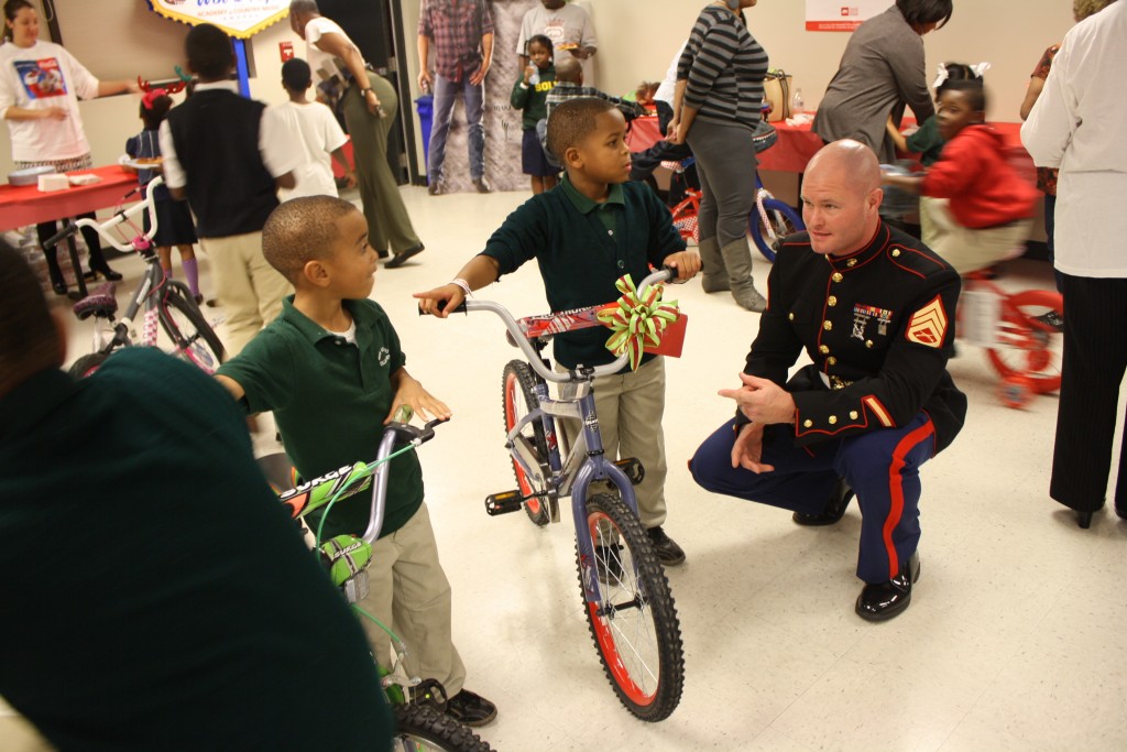 Six-year-old Makhi Davis (left) and nine-year-old Mylak (center) Davis with Staff Sgt. David Smith