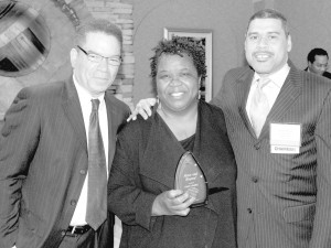 NBA President/CEO Michael Grant and NBA Chairman Doyle Mitchell award U. S. Treasury Department retiree Donna Gambrell, for her work to strengthen Black-owned banks. During her 37 years, 