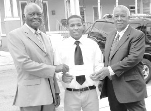 Scholarship recipient, Joseph Parker is flanked by the Rev. Johnny McKinnies and Joseph L. Williams, who presented Parker with his scholarship.