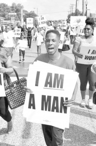 Rasheen Aldridge marches with protesters near the Ferguson Police Department in response to the shooting death of Michael Brown by former officer Darren Wilson.