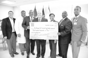 On hand for the check presentation to The Network for Community Opportunity from Wells Fargo, are from left: Councilman Jared Brossett, Henry Baptiste of New Orleans East Hospital, Councilman James Gray, Mayor Mitch Landrieu, Ashleigh Gardere, executive director of the Network for Economic Opportunity; Hugh Rowden of Wells Fargo, and Mario Garner, CEO of New Orleans East Hospital. Photo courtesy of the City of New Orleans