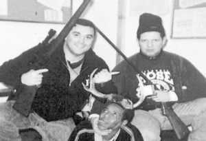 Chicago cops Jerome Finnigan (l) and Timothy McDermott (r) pose police station with an unidentified Black man wearing deer antlers as though they killed a wild animal.