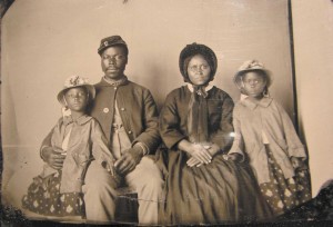 Unidentified African-American soldier in a Union uniform with his wife and two daughters.