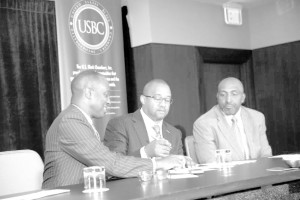 U. S. Black Chambers President/CEO Ron Busby signs Memorandum of Understanding with NAMAD President Damon Lester. Marc Bland, IHS vice president of diversity and inclusion, looks on.