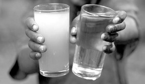 Glasses of contaminated water, left, and safe water, right