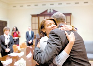 President Barack Obama hugs Kemba Smith during a greet with formerly incarcerated individuals who have received commutations, in the Roosevelt Room of the White House, March 30, 2016.