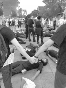 Protestors, clad in all black, call for the removal of all symbols of white supremacy during White Linen Night festivities.