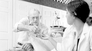 Nurse Tiffanie Abrajano checks Alton Rodgers' medications so he knows how to take them after going home from the hospital.