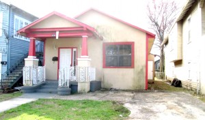 This Fannie Mae REO in an African-American neighborhood is poorly maintained with dirty walls and windows and dead leaves littering the yard.