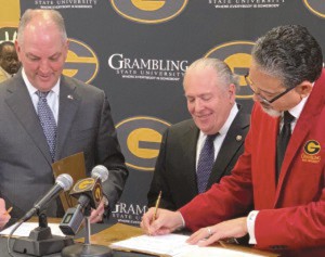 Grambling State University President Rick Gallot, right, signs a Memorandum of Understanding (MOU), partnering the university with the state's Louisiana Economic Development (LED), to create and enhance tech careers for Grambling students. Looking on is La. Governor John Bel Edward, left, and LED Secretary Don Pierson.