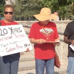 Gordon Plaza residents and activists Lydwina Hurst, Marilyn Amar and Jeffe Perkins stand in protest and remembrance