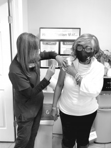 Crescent City Pharmacy Manager Dr. Lishunda Franklin vaccinates Laverne Rose, 74, on Tuesday, Jan. 5. Photo courtesy of Philip Kiefer/The Lens