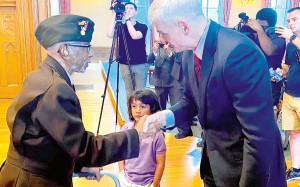 World War II veteran Johnnie Jones shakes the hand of U.S. Sen. Bill Cassidy on Saturday, June 26, 2021, during a ceremony where he was presented the Purple Heart, which is awarded to veterans wounded on the battlefield during combat. Photo courtesy of Facebook